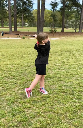 McKenzie, first time golfing at age 6.